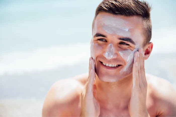 Close view of sunscreen being spread evenly on the face during an outdoor skin care routine